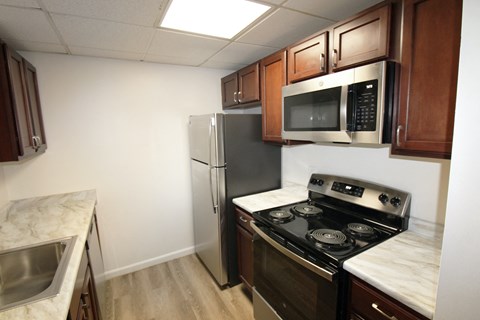 a kitchen with stainless steel appliances and wooden cabinets